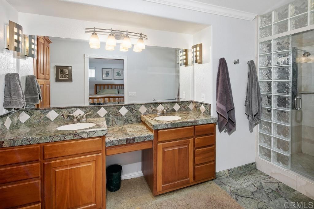 4730 Edinburgh Drive Carlsbad, CA 92010 - Photo 21 of 33 a bathroom with a granite countertop sink and a mirror