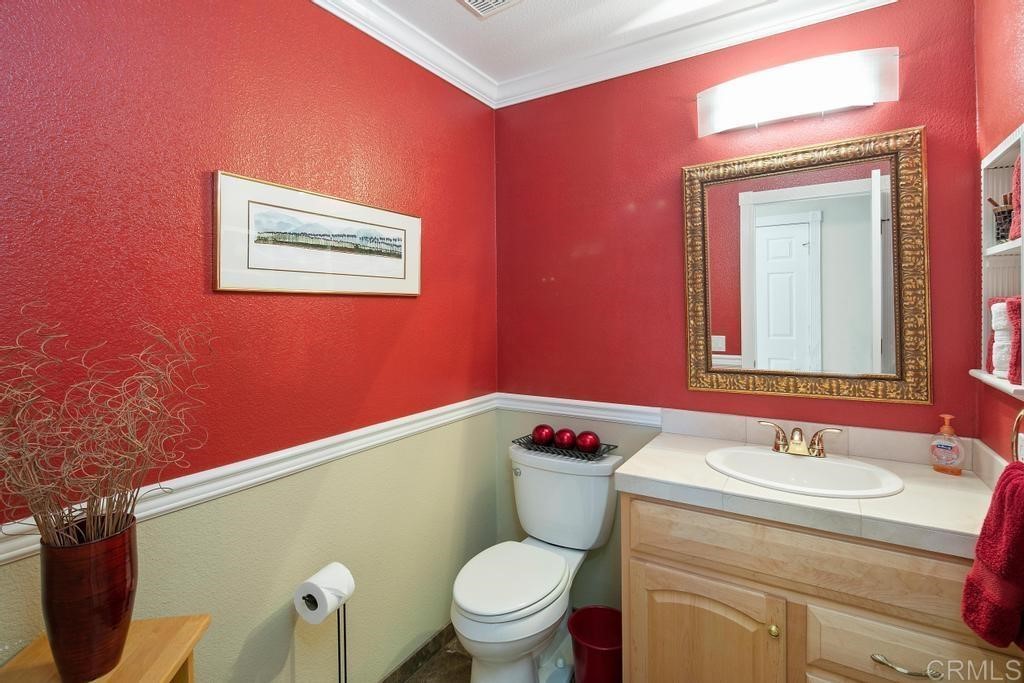 4730 Edinburgh Drive Carlsbad, CA 92010 - Photo 26 of 33 a bathroom with a toilet sink and mirror