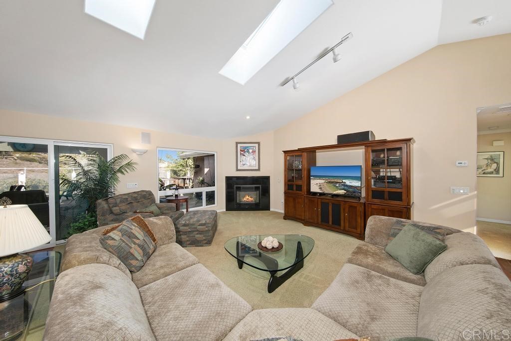 4730 Edinburgh Drive Carlsbad, CA 92010 - Photo 5 of 33 a living room with furniture flat screen tv and a fireplace