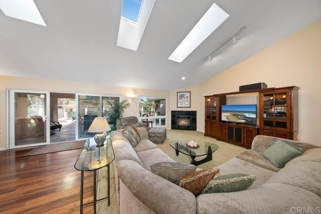 4730 Edinburgh Drive Carlsbad, CA 92010 - Photo 8 of 33 a living room with furniture flat screen tv and wooden floor