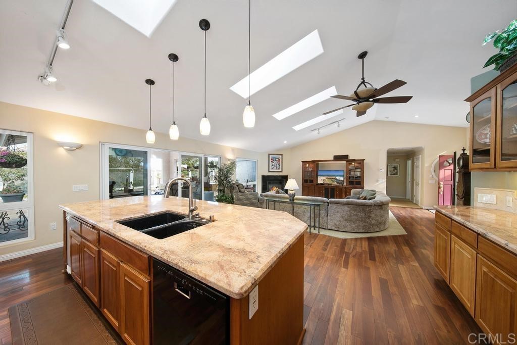 4730 Edinburgh Drive Carlsbad, CA 92010 - Photo 9 of 33 a kitchen with a stove a counter space a sink and living room view