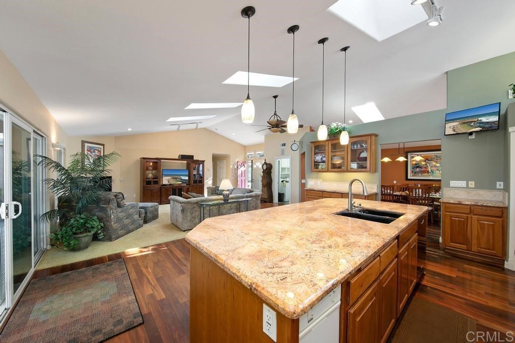 4730 Edinburgh Drive Carlsbad, CA 92010 - Photo 10 of 33 a kitchen with stainless steel appliances granite countertop a sink a counter and chairs