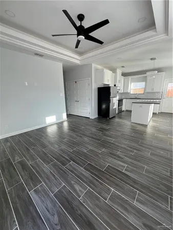 a view of empty room with wooden floor and fireplace