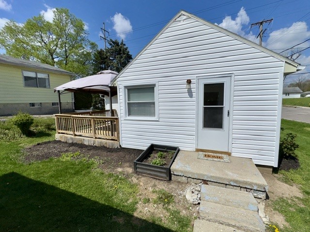 1701 West Jefferson Street Springfield, OH 45506 - Photo 6 of 18 This charming home offers a welcoming exterior with a delightful patio for outdoor enjoyment.