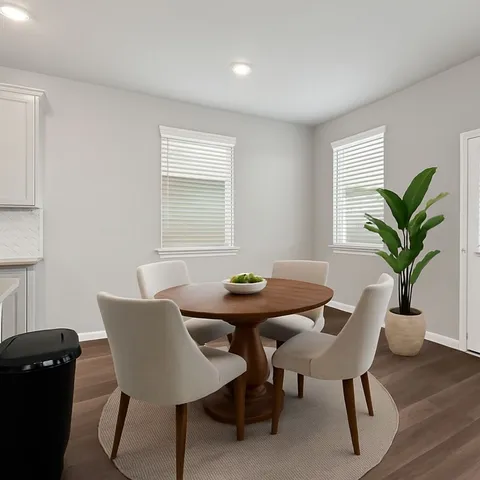 a view of a dining room with furniture and window