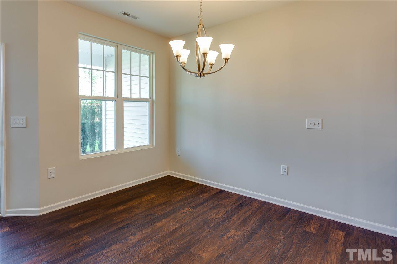 6004 Beale Loop, Unit 125 ABBEY Raleigh, NC 27616 - Photo 7 of 16 a view of empty room with wooden floor and fan