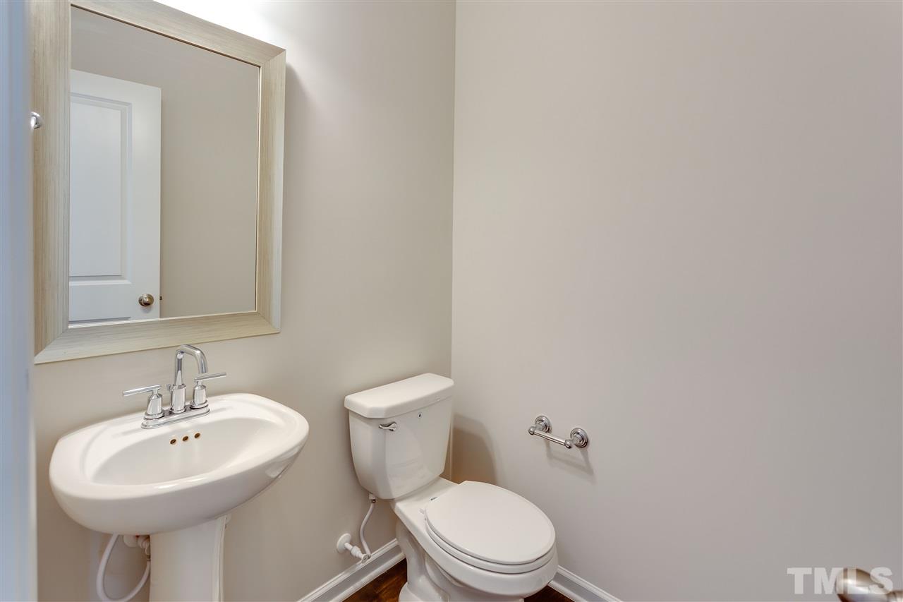 6004 Beale Loop, Unit 125 ABBEY Raleigh, NC 27616 - Photo 8 of 16 a bathroom with a sink a toilet and mirror