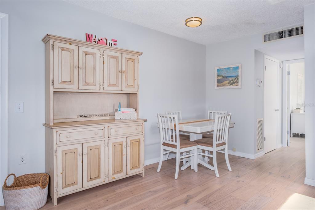 7151 Sunset Way, Unit 10 St. Pete Beach, FL 33706 - Photo 13 of 33 a kitchen with granite countertop chair and cabinets