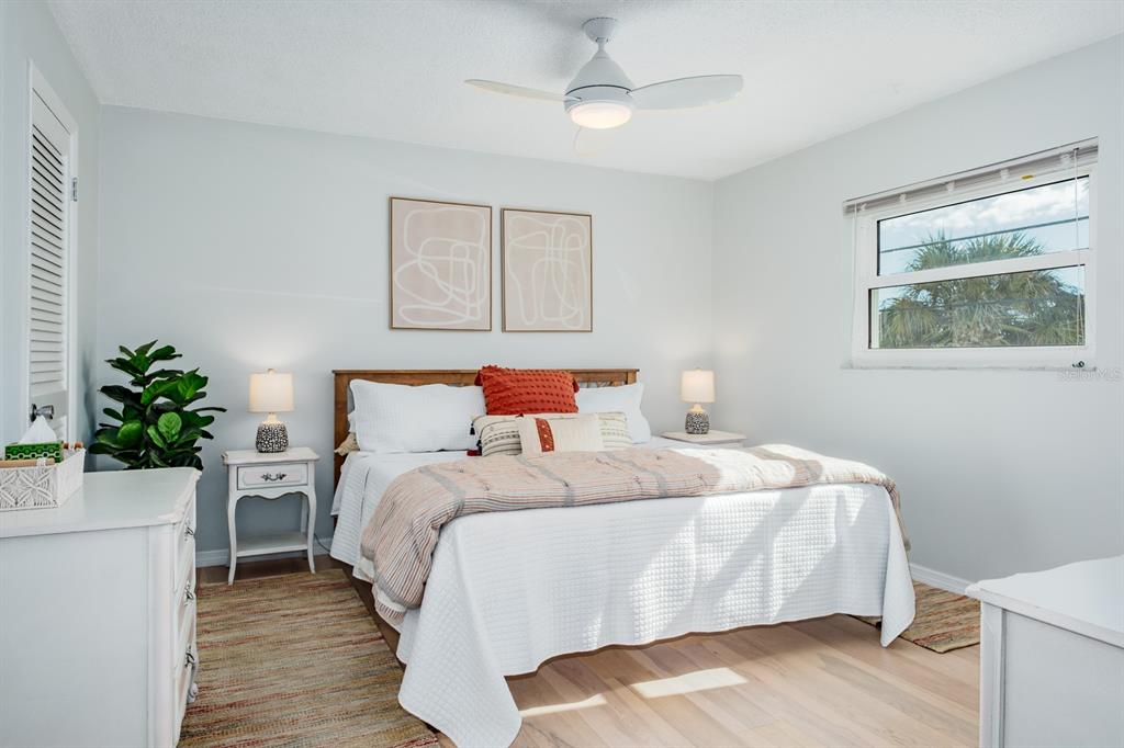 7151 Sunset Way, Unit 10 St. Pete Beach, FL 33706 - Photo 19 of 33 a bedroom with a bed and a potted plant