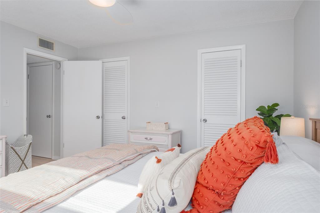 7151 Sunset Way, Unit 10 St. Pete Beach, FL 33706 - Photo 22 of 33 a bed room with a bed and a chair