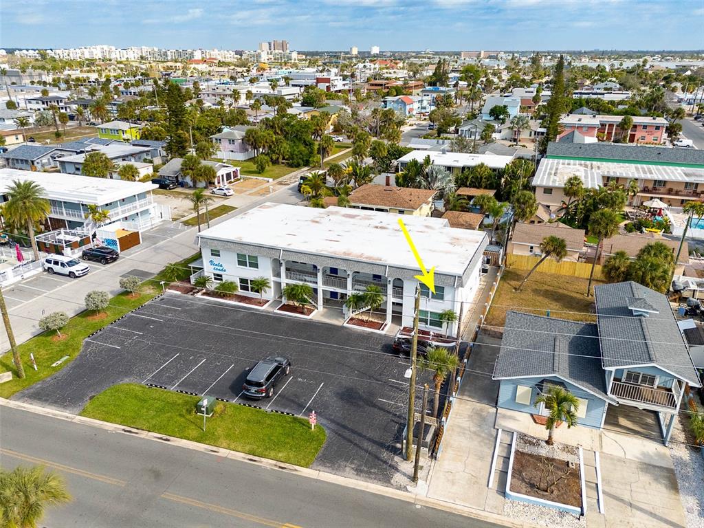 7151 Sunset Way, Unit 10 St. Pete Beach, FL 33706 - Photo 30 of 33 an aerial view of residential houses with yard