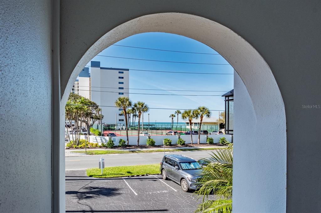 7151 Sunset Way, Unit 10 St. Pete Beach, FL 33706 - Photo 4 of 33 a picture of a table and chairs in patio