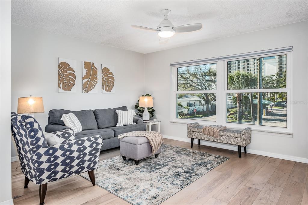7151 Sunset Way, Unit 10 St. Pete Beach, FL 33706 - Photo 10 of 33 a living room with furniture and a large window