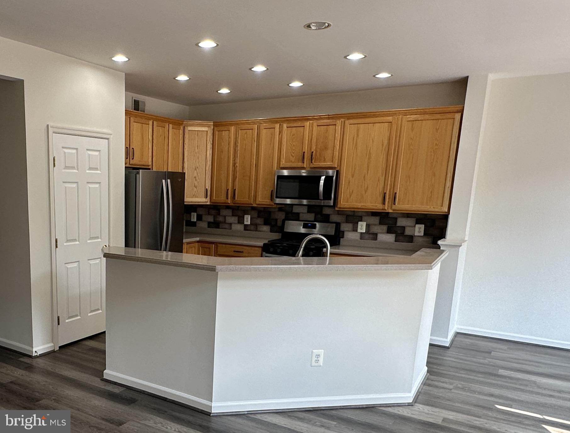 43395 Allisons Ridge Terrace Ashburn, VA 20148 - Photo 11 of 32 Modern kitchen with warm wood accents.