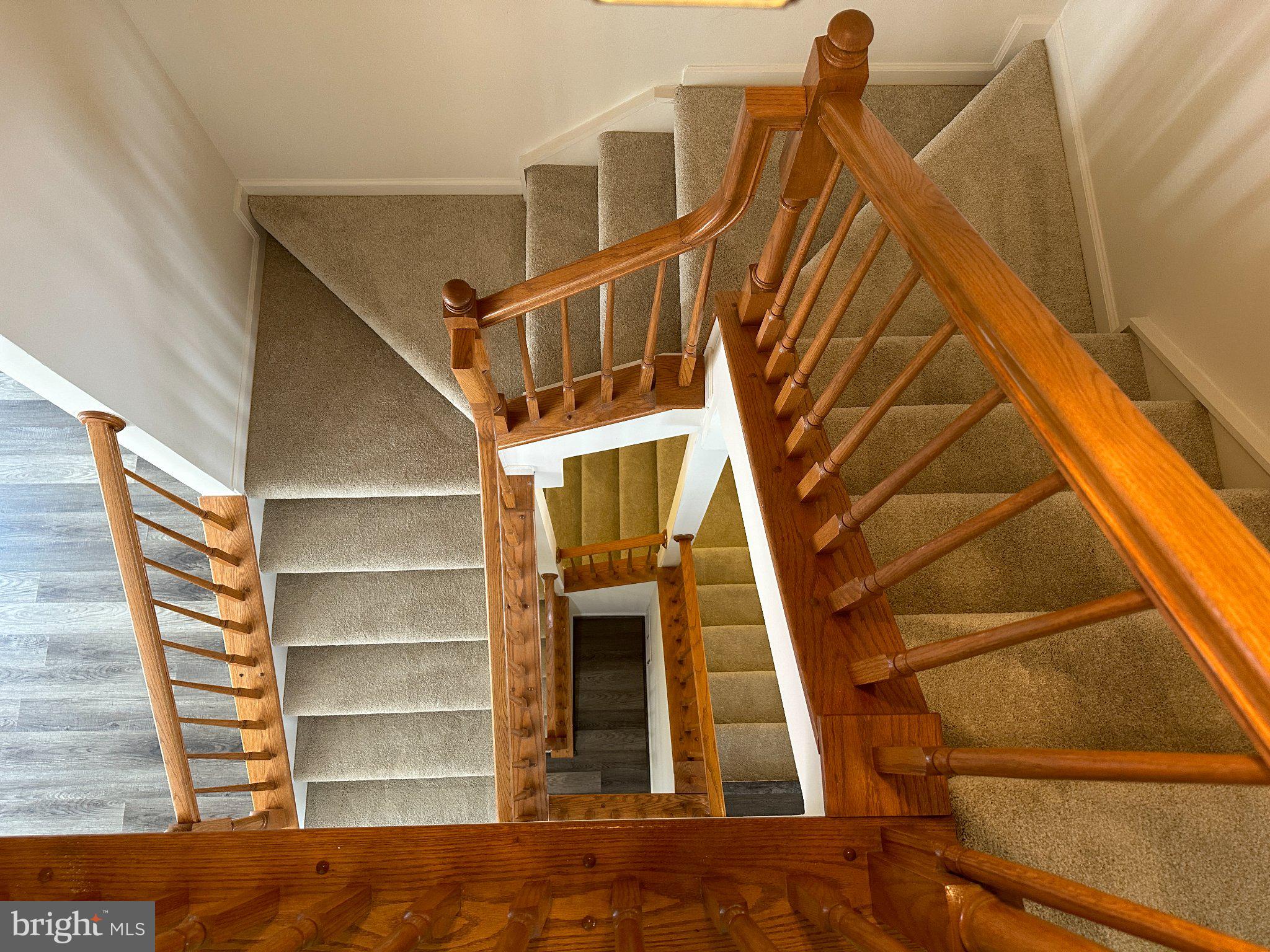 43395 Allisons Ridge Terrace Ashburn, VA 20148 - Photo 14 of 32 Elegant staircase with wooden railings.