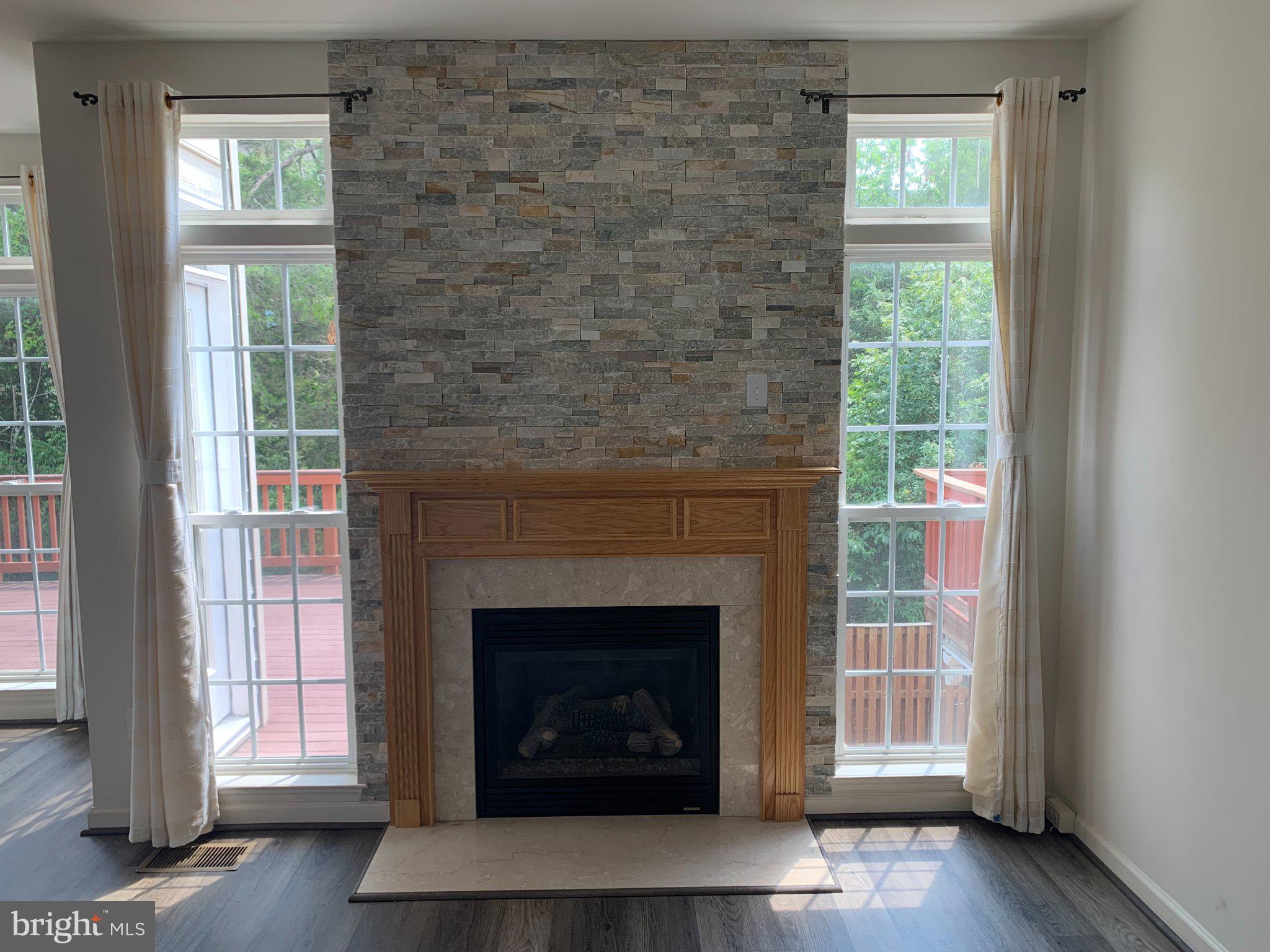 43395 Allisons Ridge Terrace Ashburn, VA 20148 - Photo 6 of 32 Bright living space with stone fireplace.