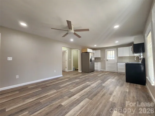 a view of an empty room with a kitchen