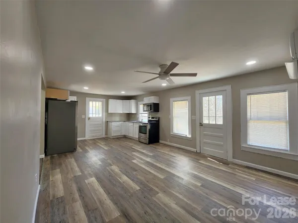 a view of a livingroom with a furniture wooden floor and window