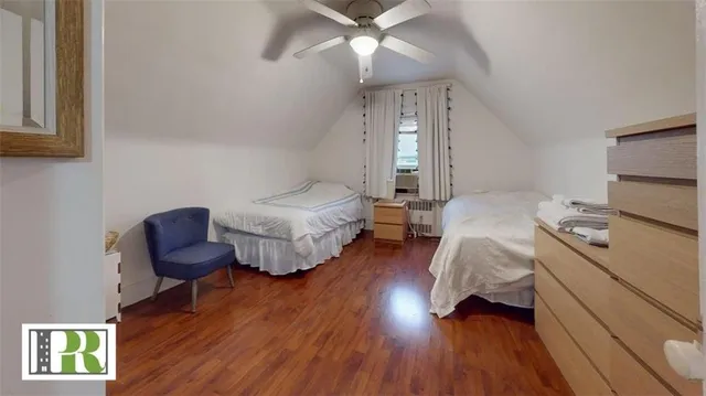 a bedroom with furniture and a wooden floor