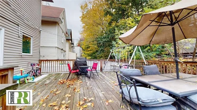 a view of balcony with wooden floor and outdoor seating