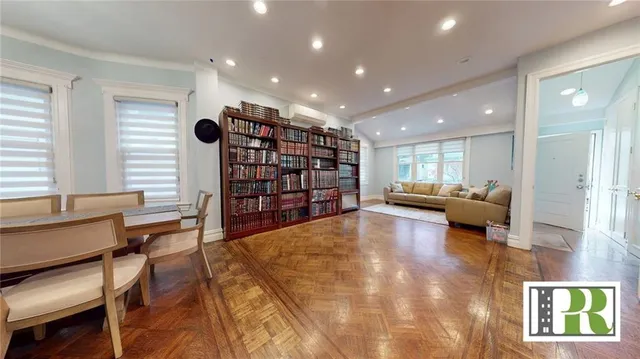 a living room with furniture and a book shelf