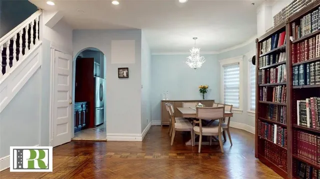 a view of a dining room with furniture and wooden floor