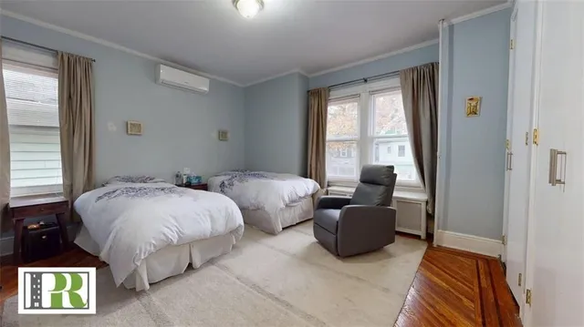 a bedroom with two beds and a window