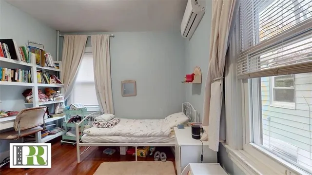 a view of a workspace with furniture and a book shelf