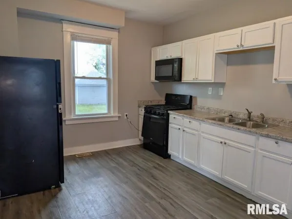 an empty room with wooden floor and closet