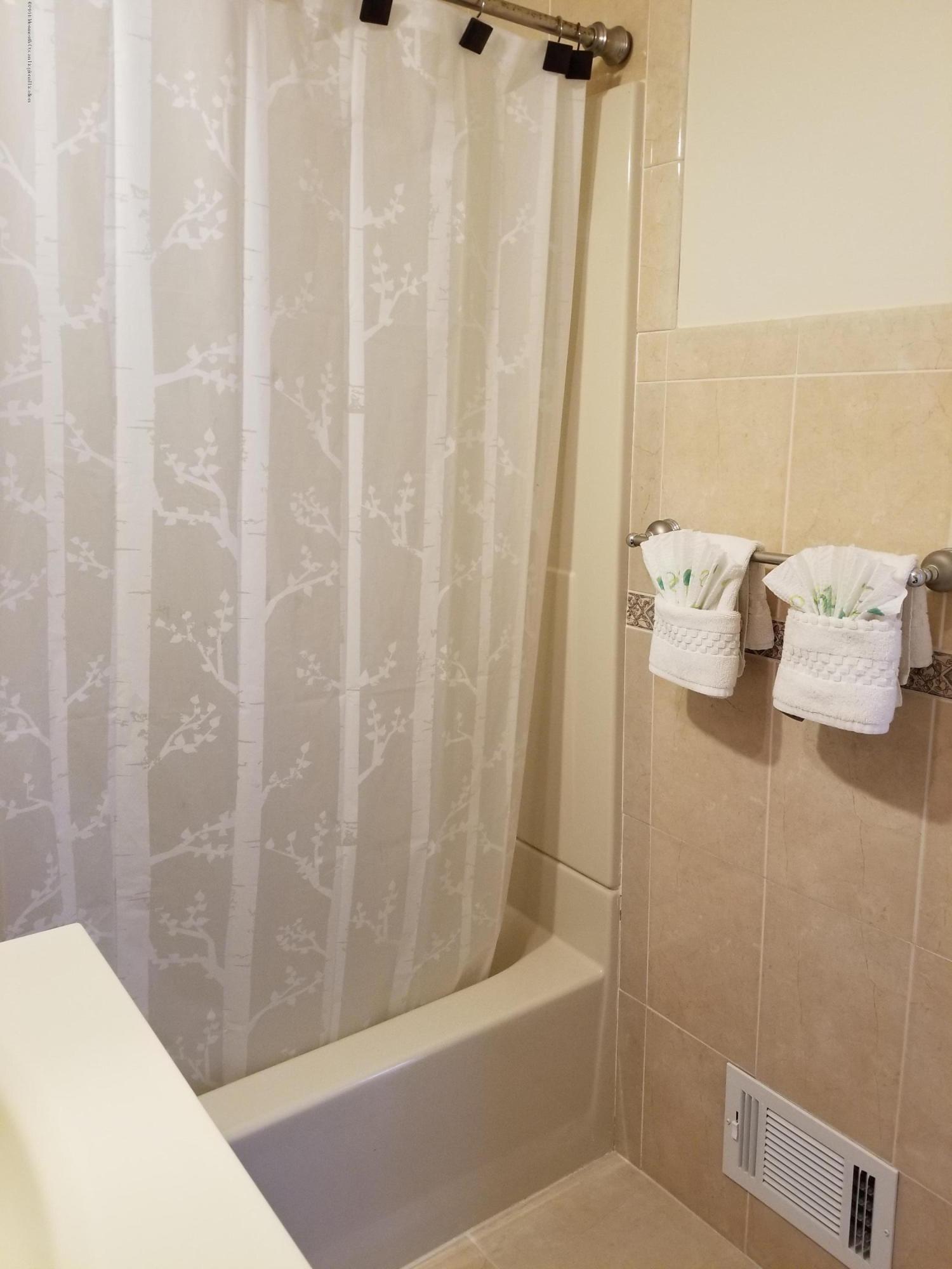 321 Spring Street, Unit 21 Red Bank, NJ 07701 - Photo 6 of 11 a bathroom with a bathtub and shower