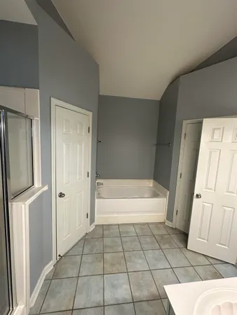 a bathroom with a bathtub and a shower