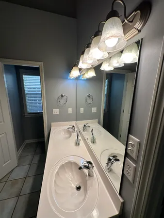 a bathroom with a sink a toilet and mirror