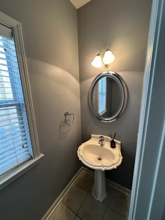 a bathroom with a sink a mirror and a toilet