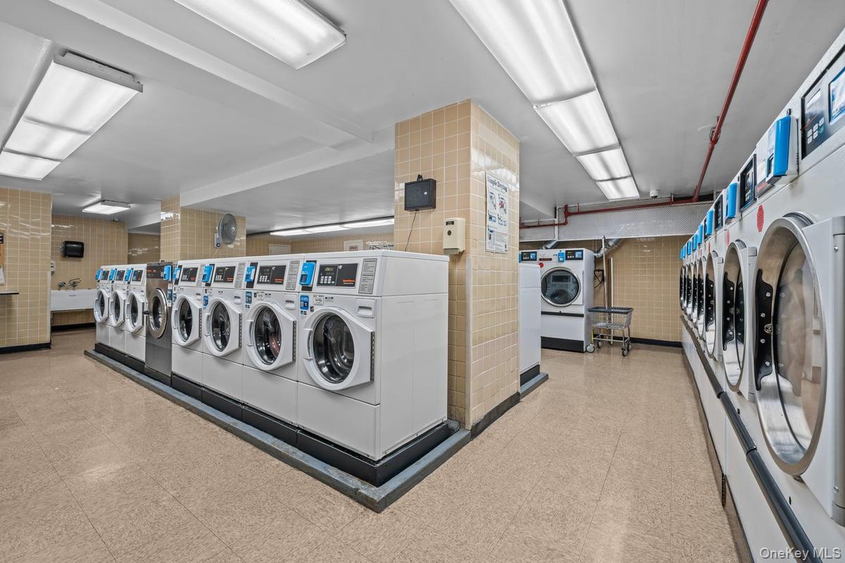 2500 Johnson Avenue North, Unit 2NP Bronx, NY 10463 - Photo 42 of 45 Shared laundry featuring tile walls, washing machine and dryer, and light flooring