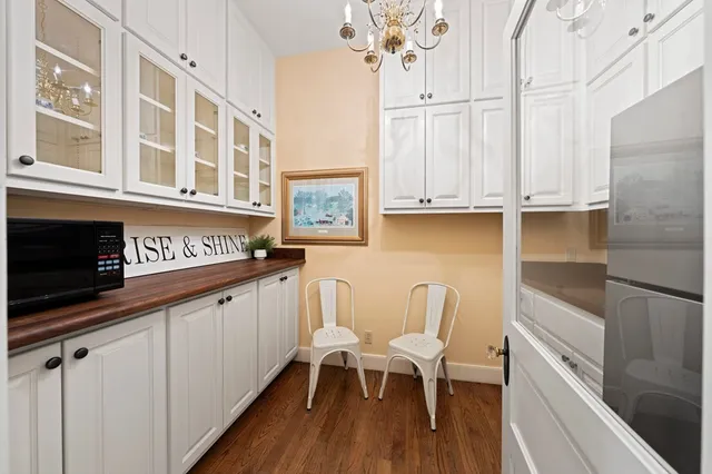 a view of a kitchen with furniture and wooden floor