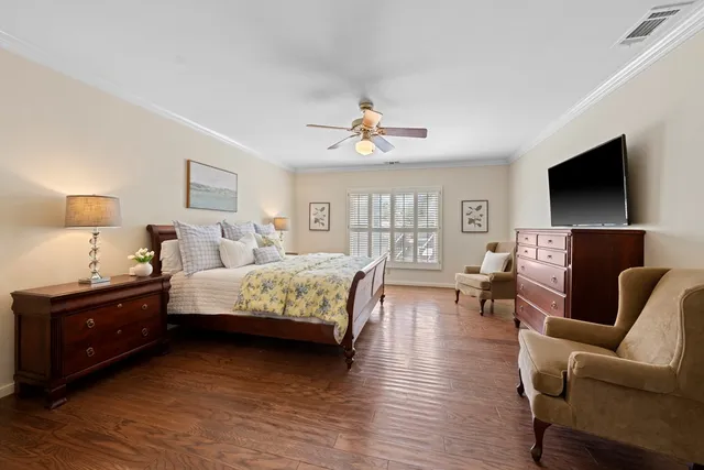 a bedroom with furniture and a flat screen tv