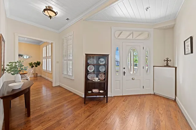a view of an entryway with wooden floor