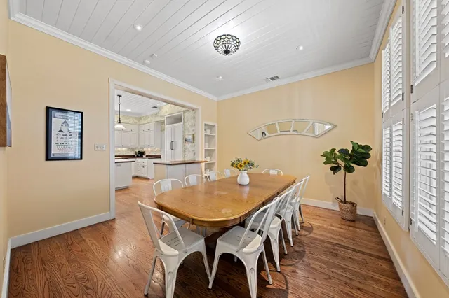 a dining room with furniture and wooden floor