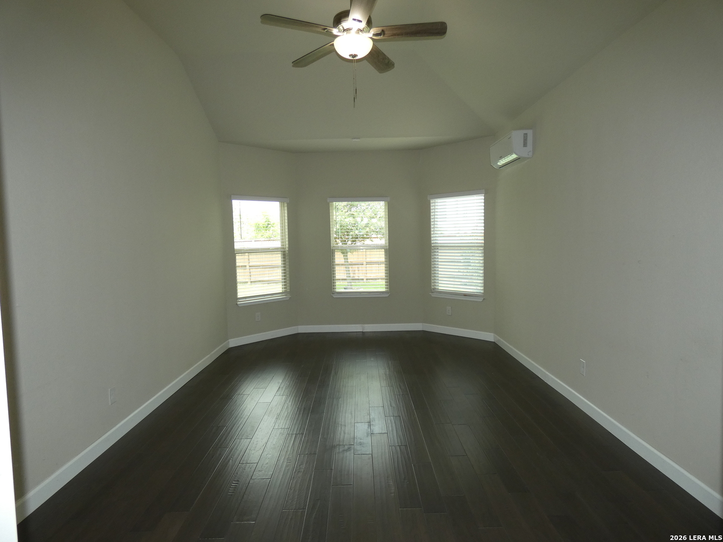 10503 Pablo Way Converse, TX 78109 - Photo 10 of 21 a view of an empty room with wooden floor and a window