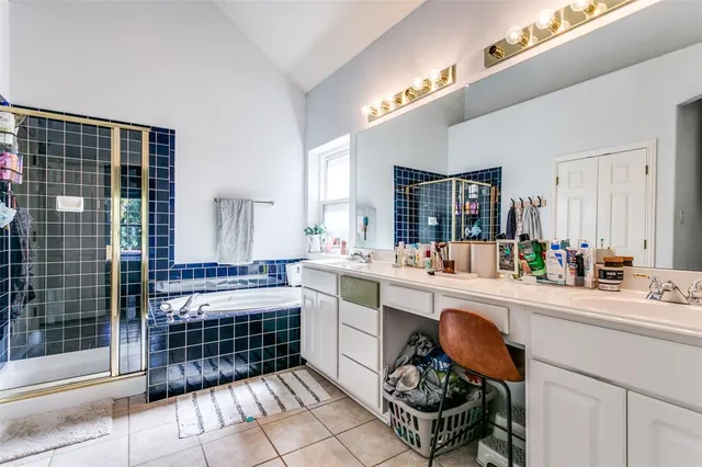 a large white kitchen with a sink and dishwasher a stove with wooden floor
