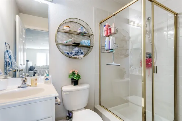 a bathroom with a toilet a sink and a mirror