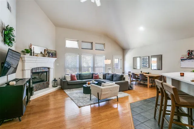 a living room with furniture a fireplace and a large window
