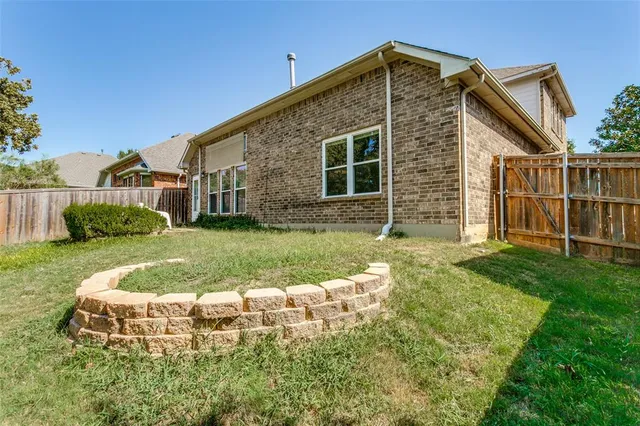 a view of a house with yard and sitting area
