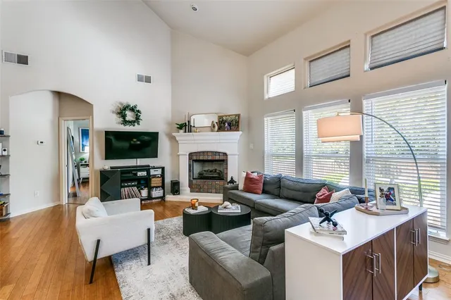 a living room with furniture a large window and a fireplace