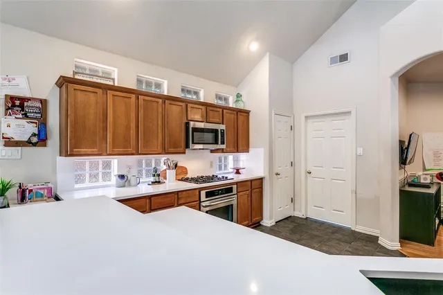 a kitchen with a sink stove and cabinets