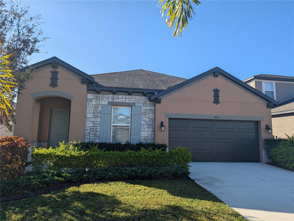 8545 Cache Drive Sarasota, FL 34240 - Photo 1 of 38 a front view of a house with garden