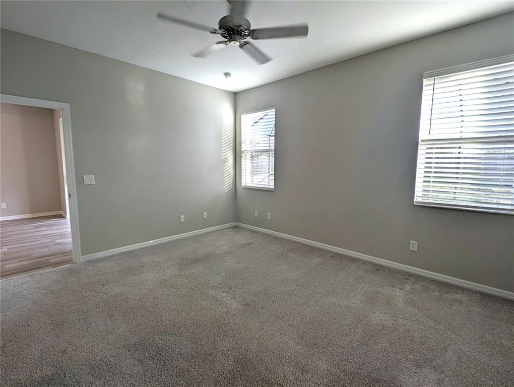 8545 Cache Drive Sarasota, FL 34240 - Photo 14 of 38 an empty room with windows and fan