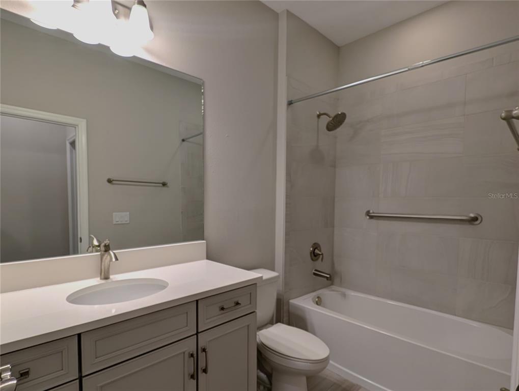 8545 Cache Drive Sarasota, FL 34240 - Photo 24 of 38 a bathroom with a sink toilet a vanity and shower