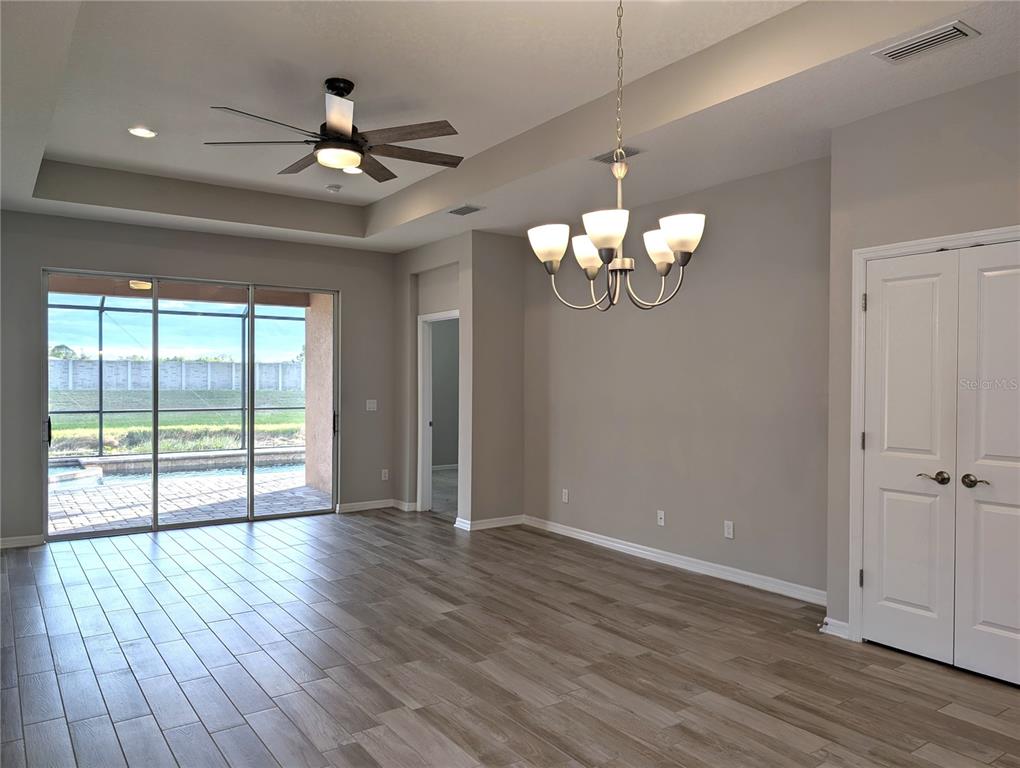 8545 Cache Drive Sarasota, FL 34240 - Photo 3 of 38 a view of an empty room with wooden floor and a window