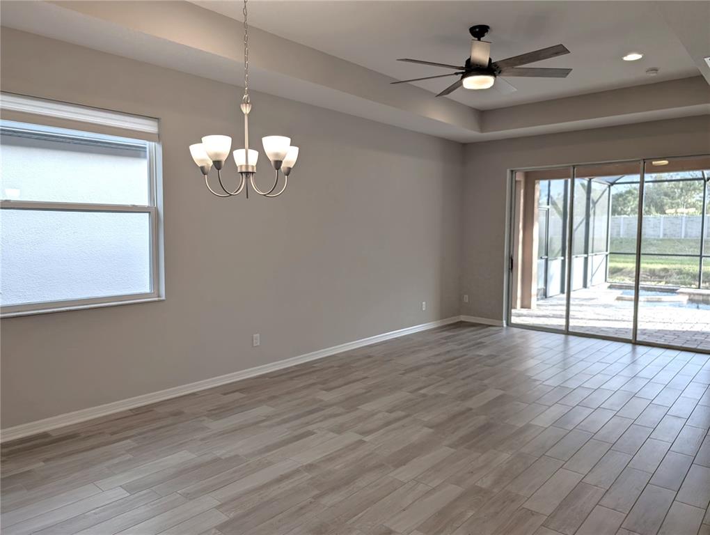 8545 Cache Drive Sarasota, FL 34240 - Photo 4 of 38 a view of an empty room with wooden floor and a window